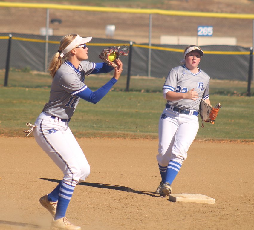 FLHS shortstop Gen Hunt squeezes the pop fly for an out as second baseperson Reagan Mewbourn moves toward the bag in case of a throw.